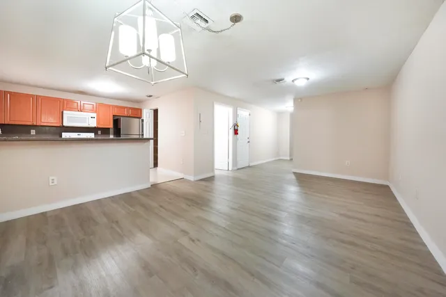a view of a kitchen with a dishwasher and wooden floor