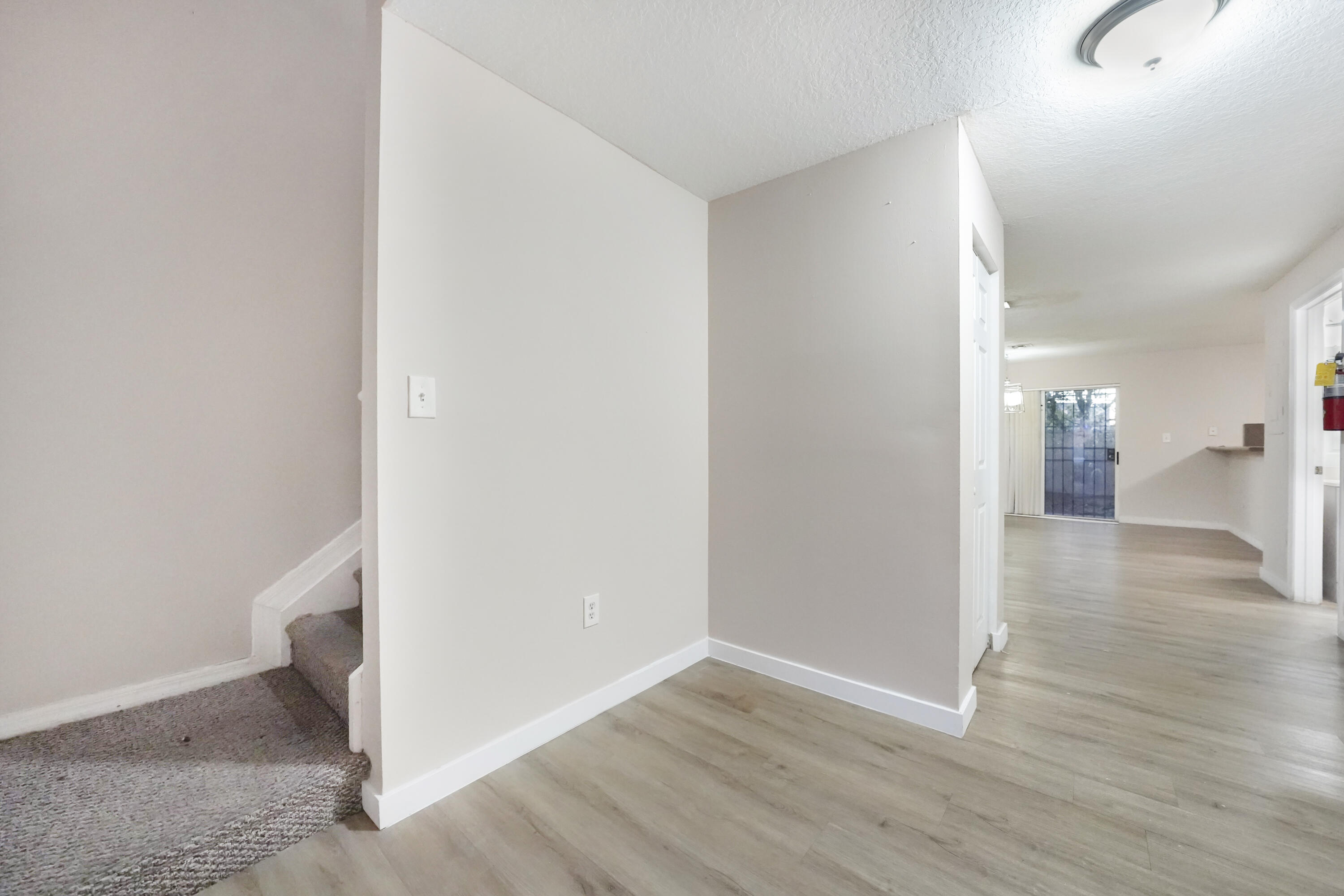 14142 Southwest 260th Street, Unit 105 Homestead, FL 33032 - Photo 6 of 17 a view of a hallway with wooden floor