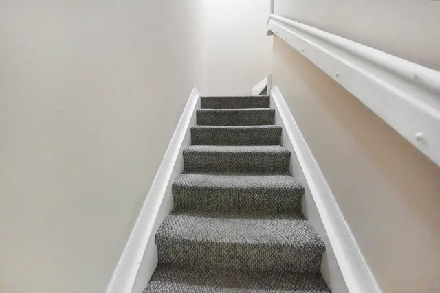 a view of staircase with white walls