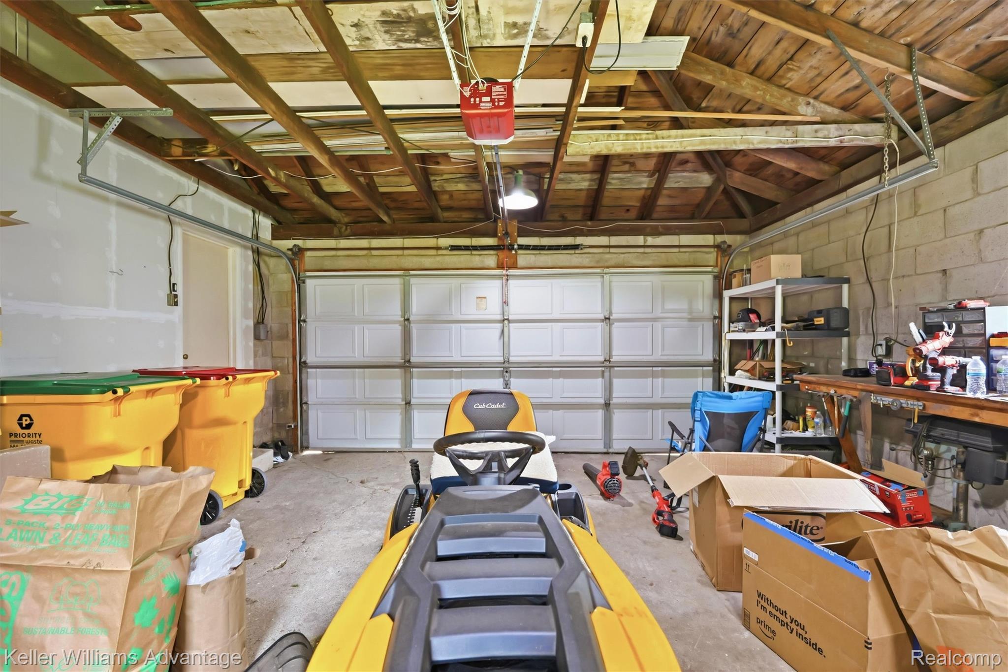 6595 Bray Road Vassar, MI 48768 - Photo 39 of 64 Garage with concrete block wall and a garage door opener