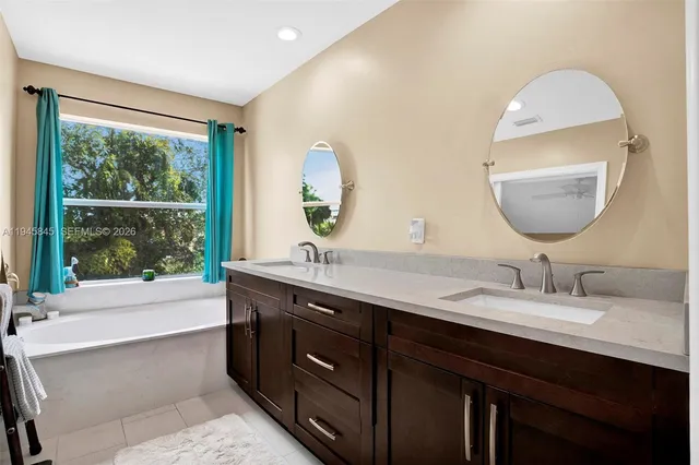a bathroom with a double vanity sink and a mirror