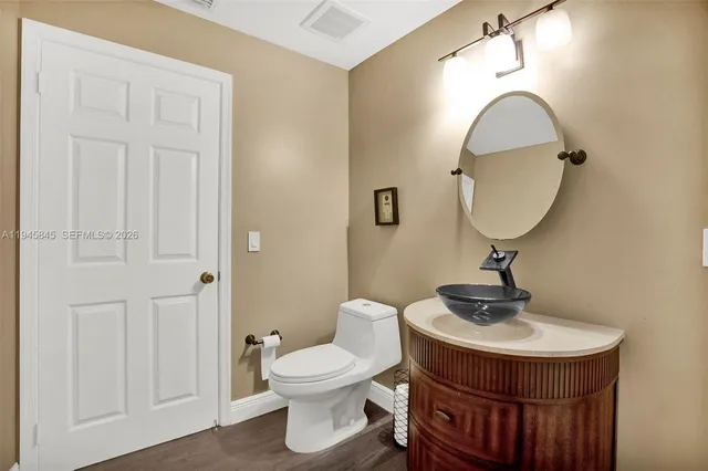 a bathroom with a toilet a sink and mirror