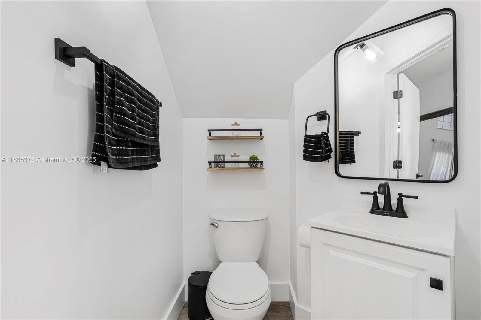 11532 Southwest 148th Path Miami, FL 33196 - Photo 14 of 36 a bathroom with a toilet sink and mirror