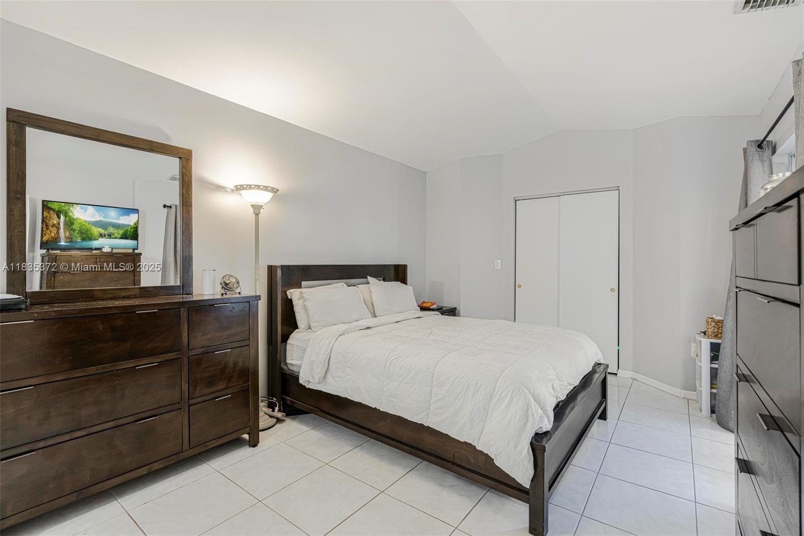 11532 Southwest 148th Path Miami, FL 33196 - Photo 16 of 36 a bedroom with a bed and a large mirror