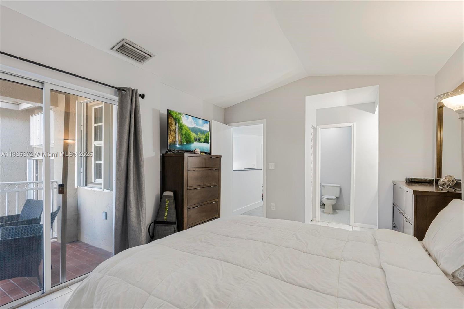 11532 Southwest 148th Path Miami, FL 33196 - Photo 17 of 36 a bedroom with a large bed and a chandelier