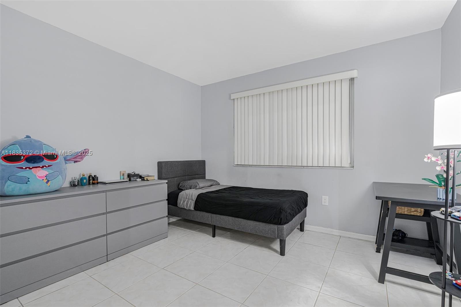 11532 Southwest 148th Path Miami, FL 33196 - Photo 21 of 36 a bedroom with furniture and a window