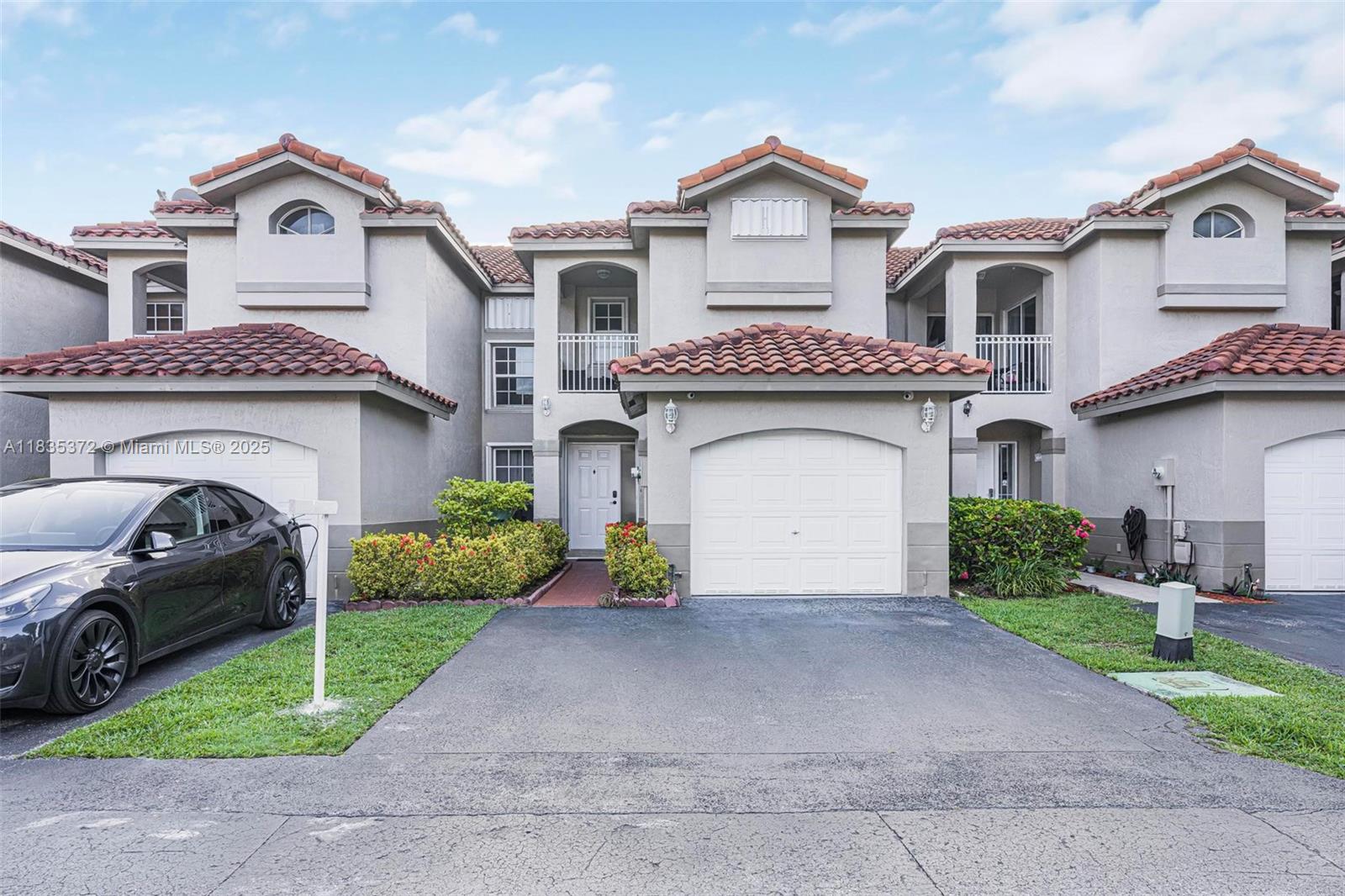 11532 Southwest 148th Path Miami, FL 33196 - Photo 34 of 36 a front view of a house with a yard and garage