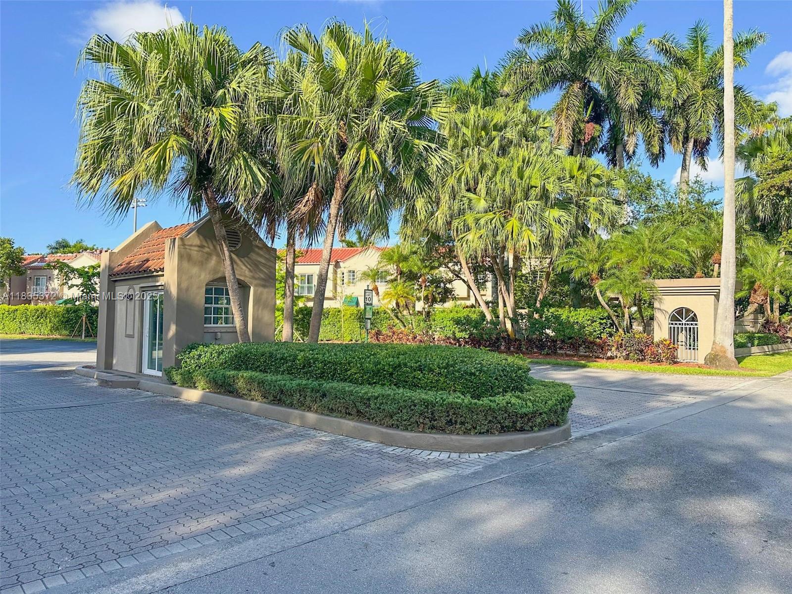 11532 Southwest 148th Path Miami, FL 33196 - Photo 35 of 36 a front view of a house with a yard and potted plants