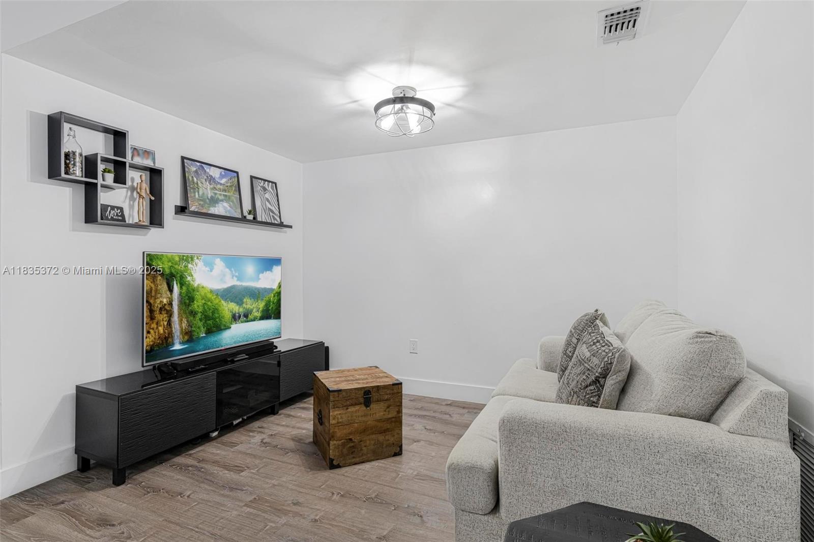 11532 Southwest 148th Path Miami, FL 33196 - Photo 8 of 36 a living room with furniture and a flat screen tv