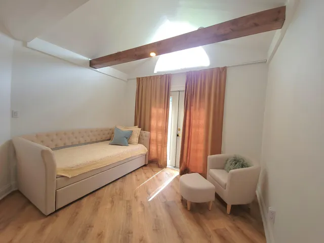 a spacious bedroom with a bed and a couch