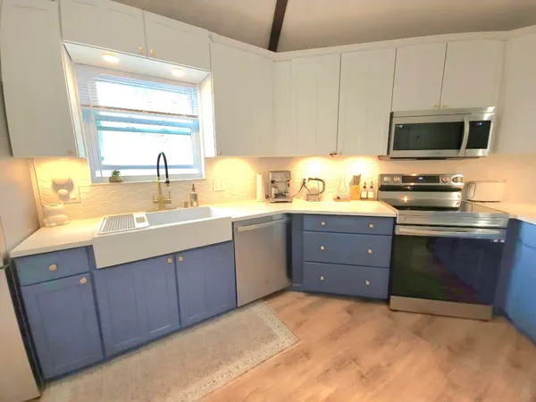 a kitchen with a sink stove and microwave