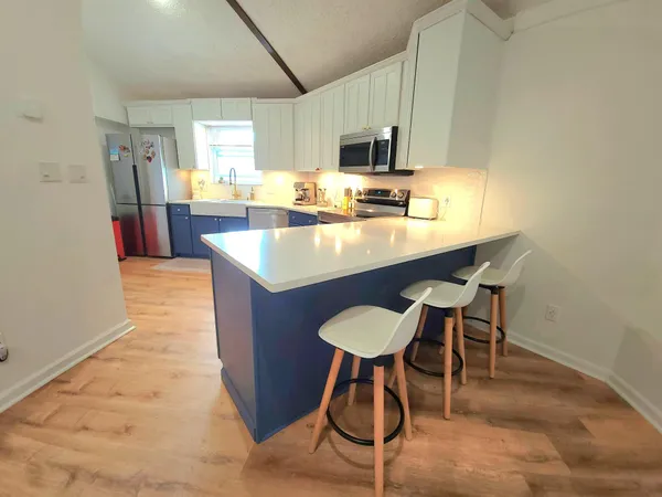 a kitchen with a sink cabinets and window