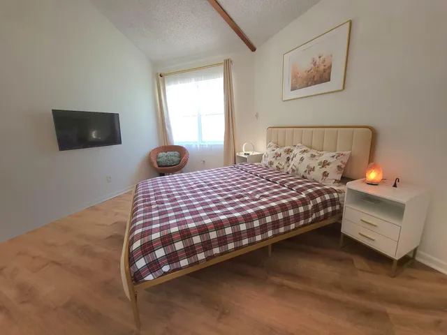 a bedroom with a bed and a window