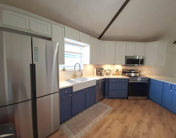 a kitchen with stainless steel appliances granite countertop a refrigerator sink and cabinets