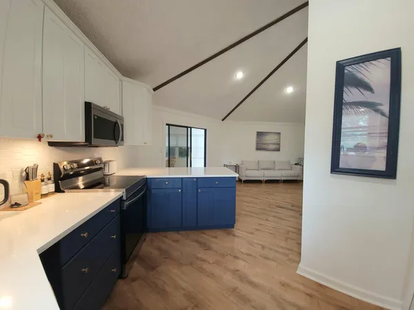 a kitchen with stainless steel appliances granite countertop a sink stove and wooden cabinets