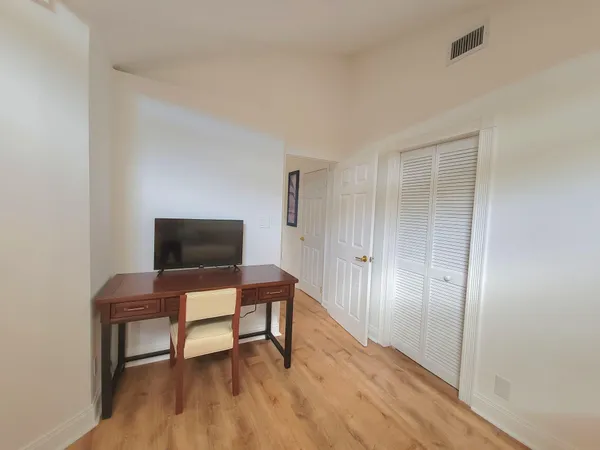 a workspace room with furniture and wooden floor