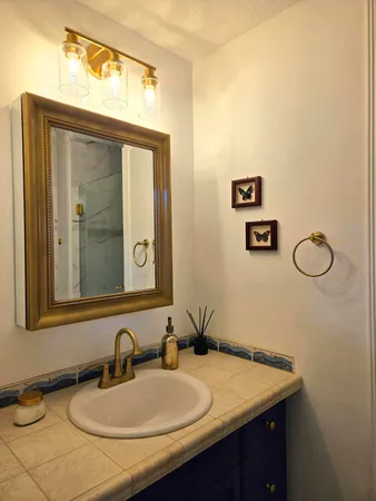 a bathroom with a sink vanity and mirror