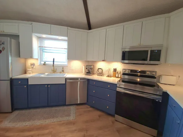 a kitchen with a sink a stove and microwave