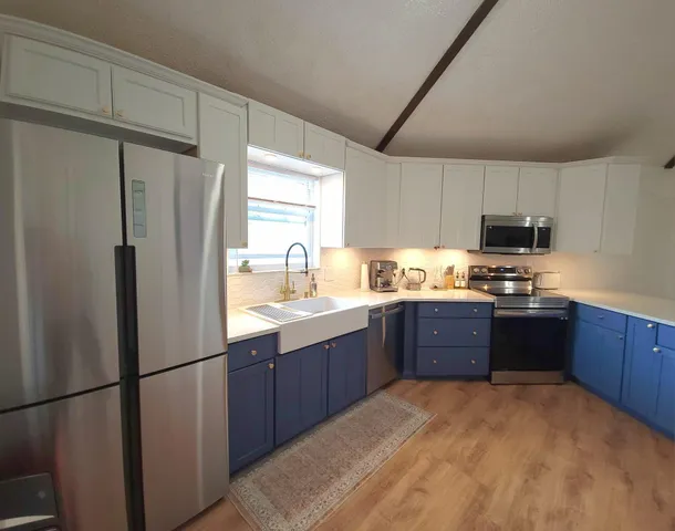 a kitchen with stainless steel appliances granite countertop a refrigerator sink and cabinets