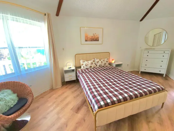 a bedroom with a bed and window