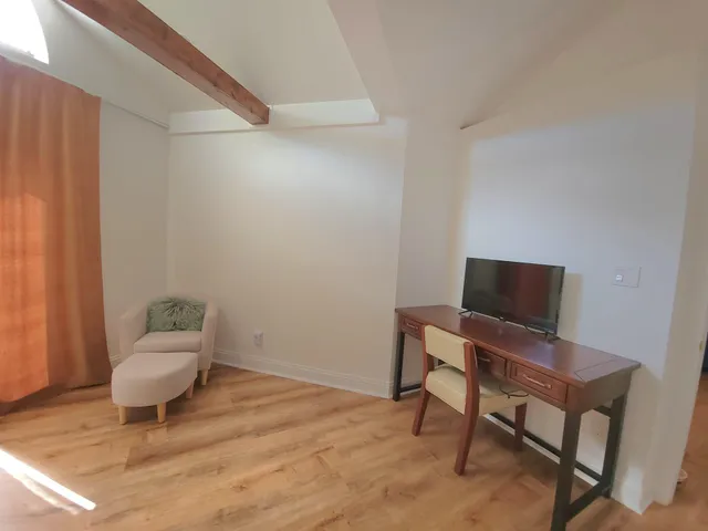 a living room with furniture and a chair