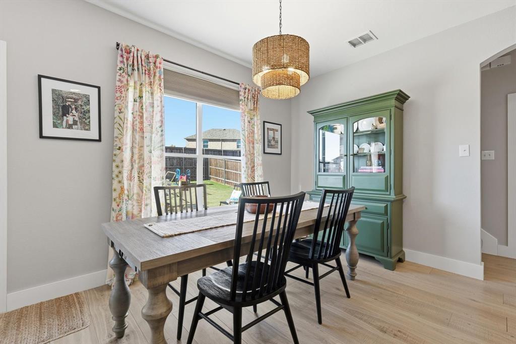 3618 Applewood Road Melissa, TX 75454 - Photo 13 of 39 a view of a dining room with furniture wooden floor and a chandelier