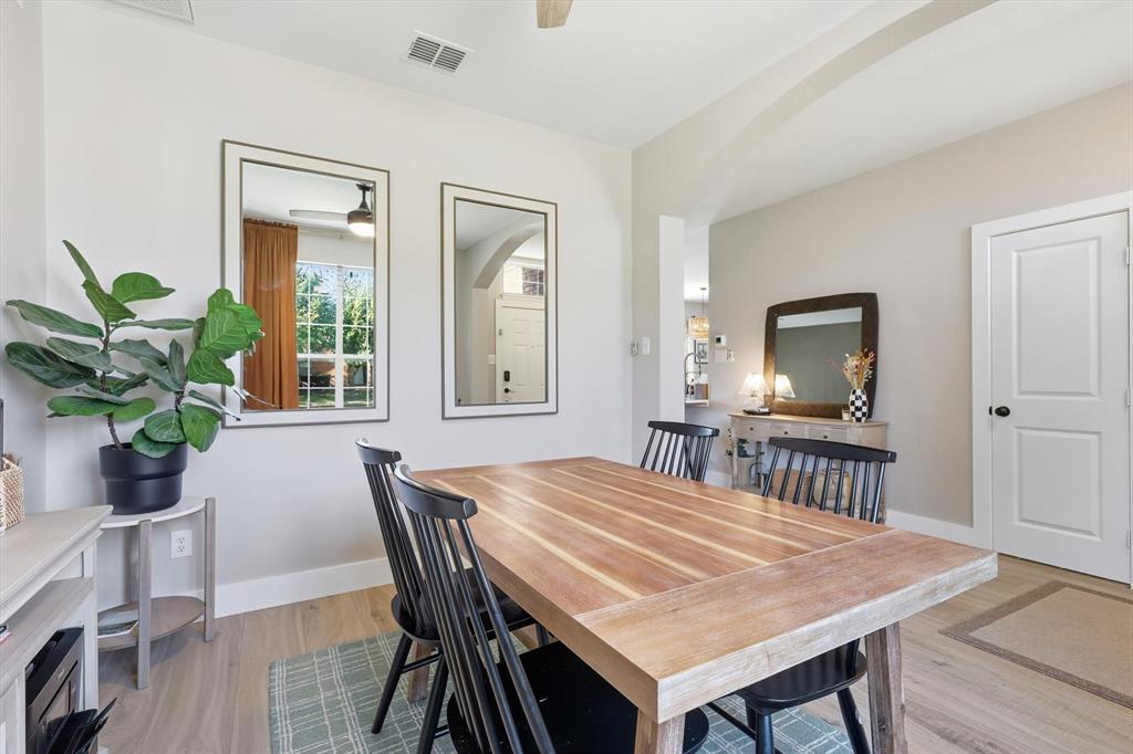 3618 Applewood Road Melissa, TX 75454 - Photo 6 of 39 a dining room with furniture potted plants and wooden floor