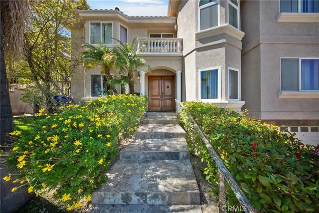 a front view of a house with garden