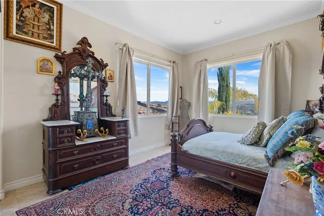 a bedroom with furniture and wooden floor