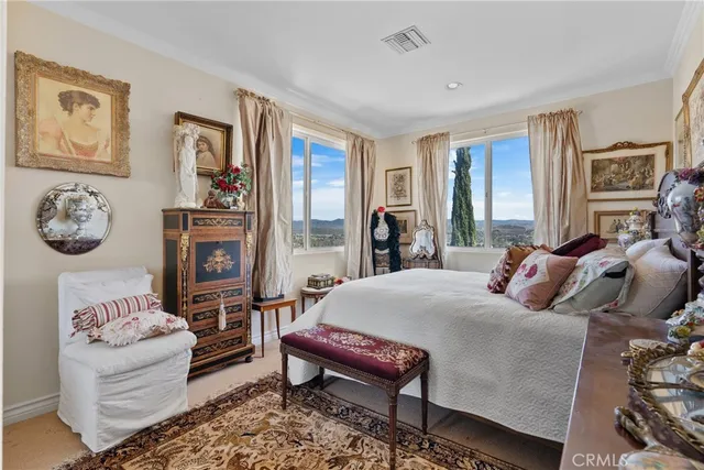 a bedroom with furniture and a large window