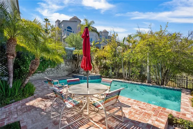 a view of a chairs and table in backyard of the house