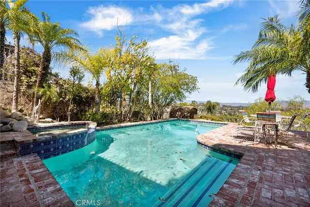 a view of a backyard with swimming pool