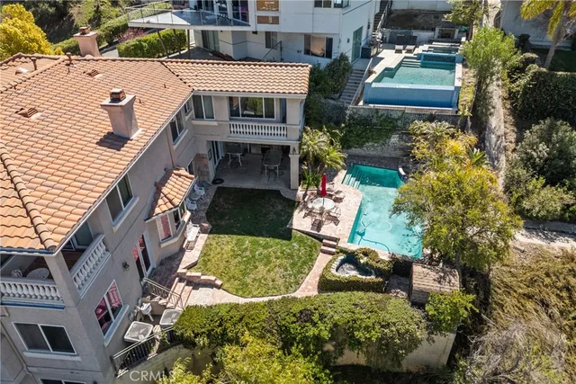 an aerial view of a house with a yard and potted plants