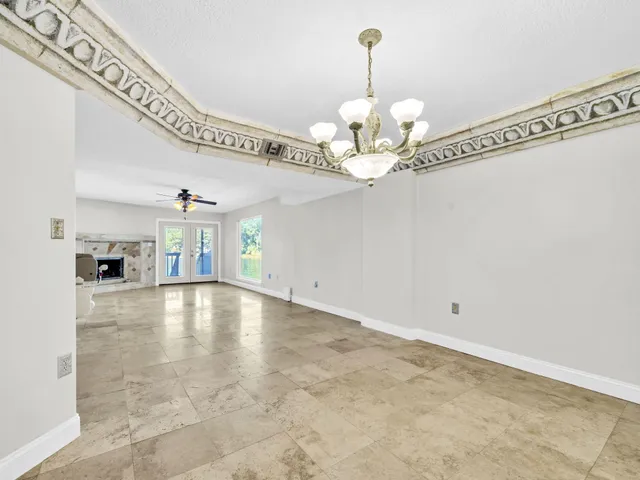 a view of an empty room with glass door and balcony