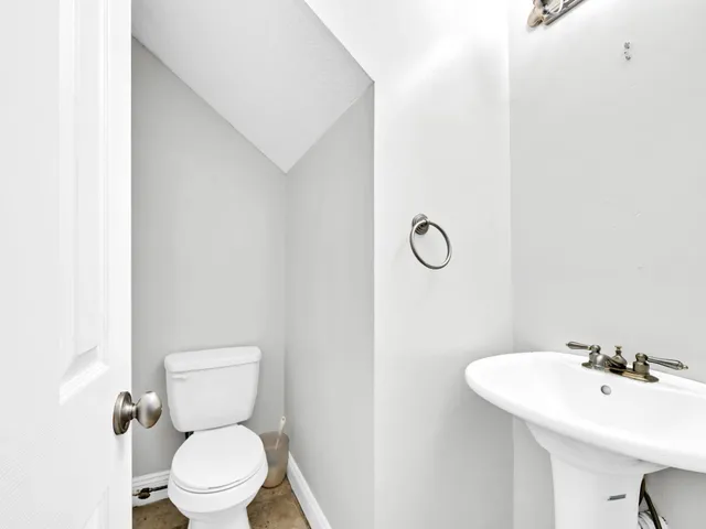 a kitchen with granite countertop white cabinets and stainless steel appliances