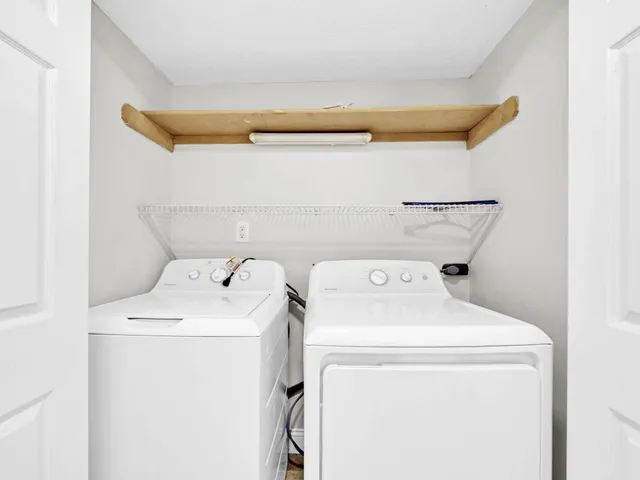 a kitchen with stainless steel appliances granite countertop a refrigerator and white cabinets