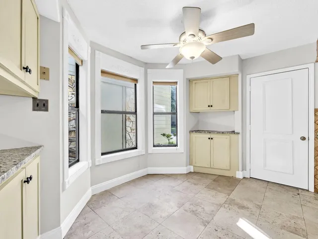 a kitchen with granite countertop cabinets stainless steel appliances and a counter space