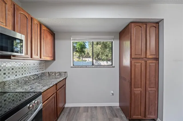 a kitchen with granite countertop cabinets washer and dryer