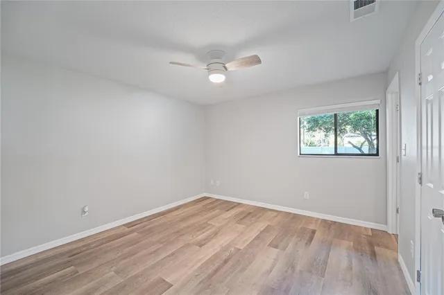 a view of a room with wooden floor and bathroom view