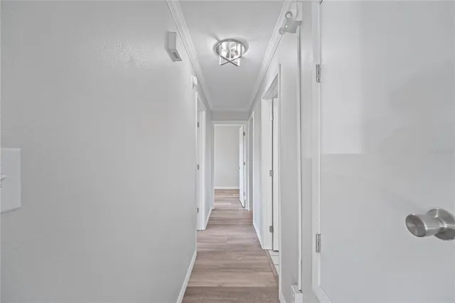 a view of a hallway with wooden floor
