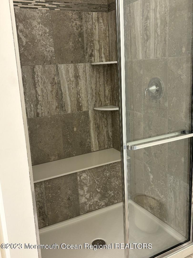 12 Harvest Ridge Road Howell, NJ 07731 - Photo 12 of 27 a bathroom with a glass shower door