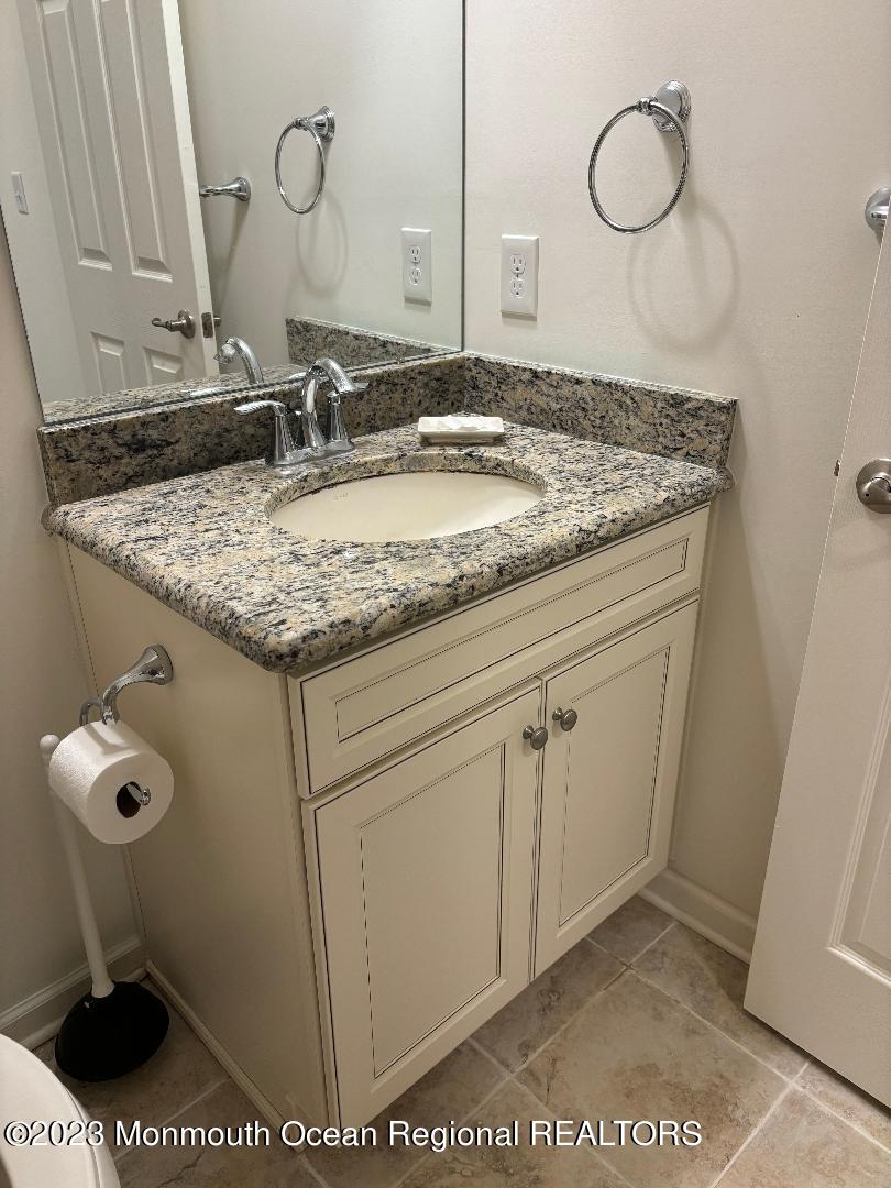 12 Harvest Ridge Road Howell, NJ 07731 - Photo 20 of 27 a bathroom with a granite countertop sink and a mirror