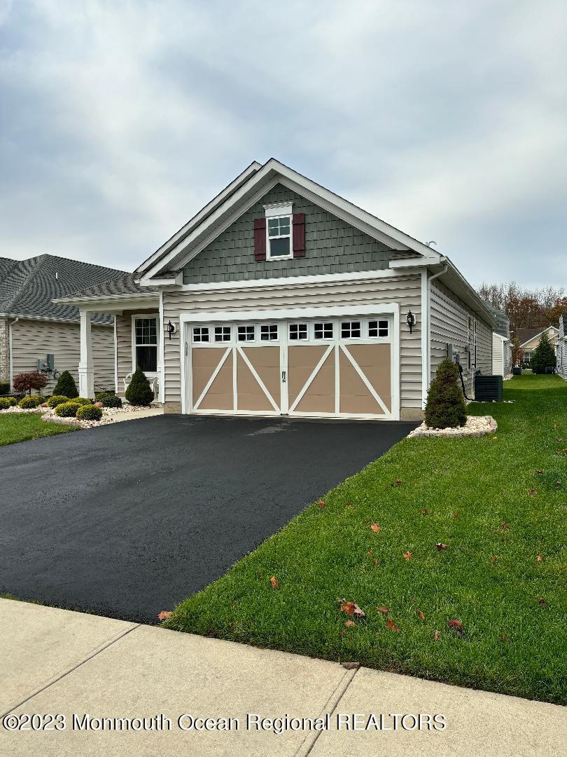 12 Harvest Ridge Road Howell, NJ 07731 - Photo 2 of 27 a front view of a house with a yard