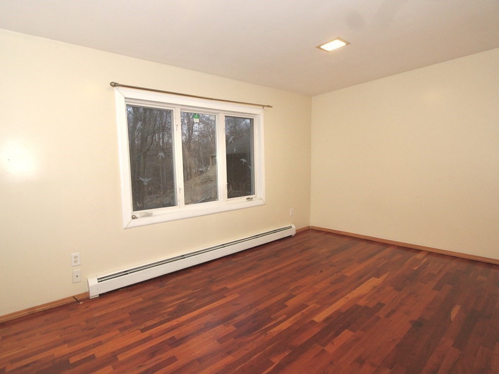 4 Carl Street Worcester, MA 01607 - Photo 13 of 27 a view of an empty room with wooden floor and a window