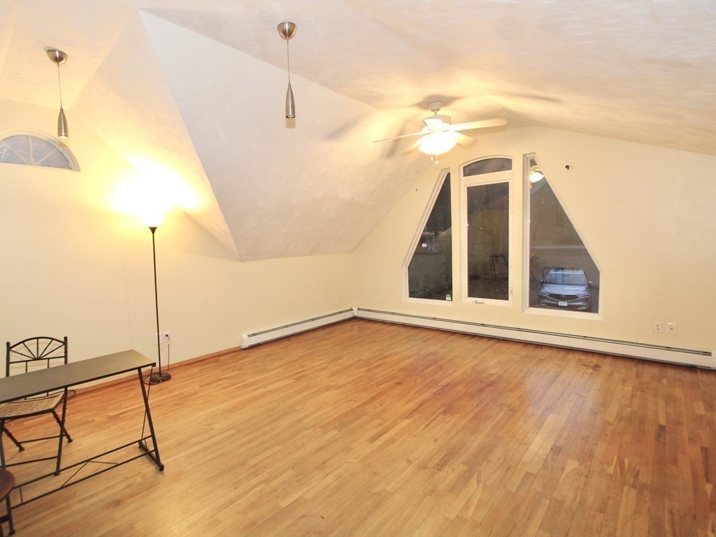 4 Carl Street Worcester, MA 01607 - Photo 15 of 27 a view of an empty room with wooden floor and a ceiling fan