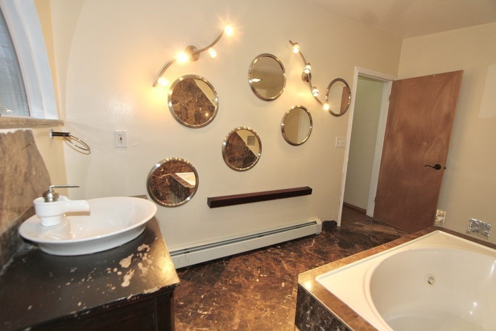 4 Carl Street Worcester, MA 01607 - Photo 20 of 27 a bathroom with a sink and a mirror