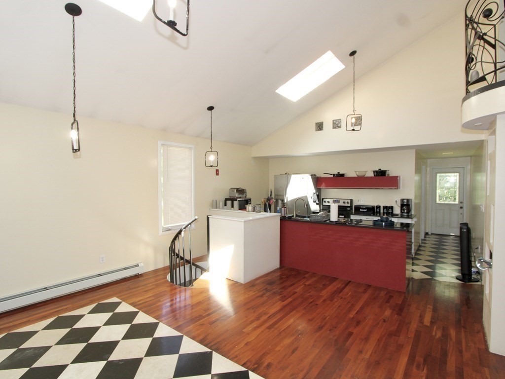 4 Carl Street Worcester, MA 01607 - Photo 6 of 27 a kitchen with stainless steel appliances granite countertop a refrigerator and a stove top oven