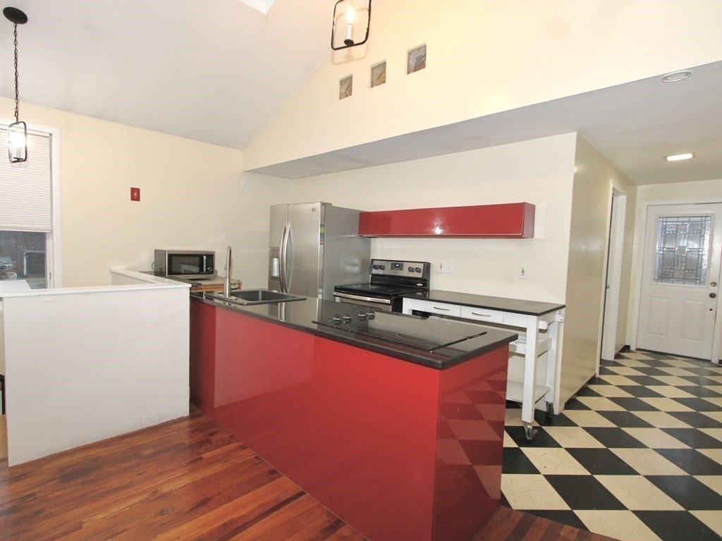 4 Carl Street Worcester, MA 01607 - Photo 8 of 27 a kitchen with stainless steel appliances a sink and a refrigerator