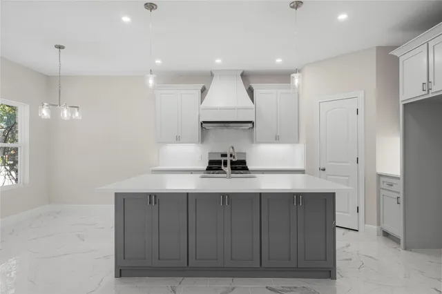 a kitchen with kitchen island a sink stainless steel appliances and cabinets
