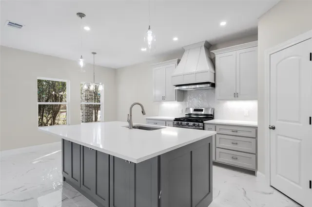a kitchen with a sink stove and cabinets